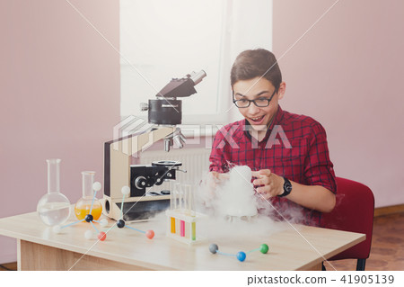 Boy doing experiment with nitrogen in laboratory Boy doing experiment with nitrogen in laboratory 41905139