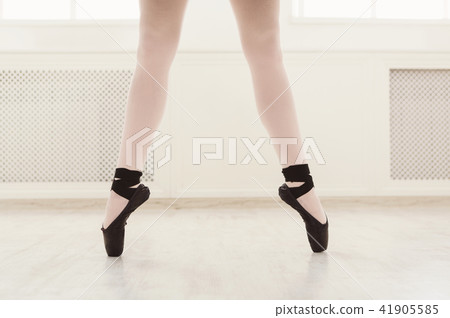 Ballerina in pointe shoes, graceful legs, ballet background Ballerina in pointe shoes, graceful legs, ballet background 41905585