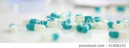 Tablets scattered on the table of the pharmaceutical 41906242