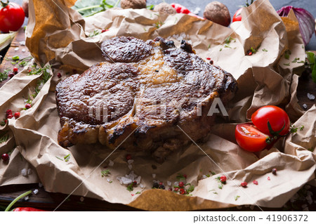 Rib eye steak on cooking paper, parchment close up 41906372