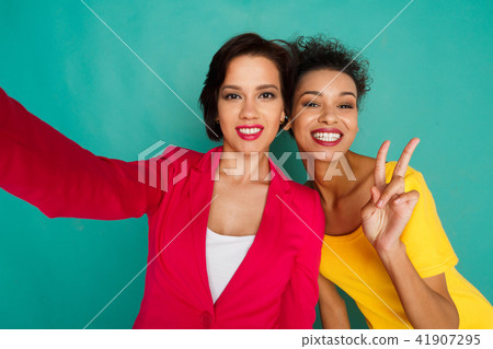 Two girlfriends having fun at azur studio background Two girlfriends having fun at azur studio background 41907295