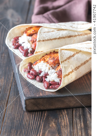 Chicken burritos on the wooden board Chicken burritos on the wooden board 41907742