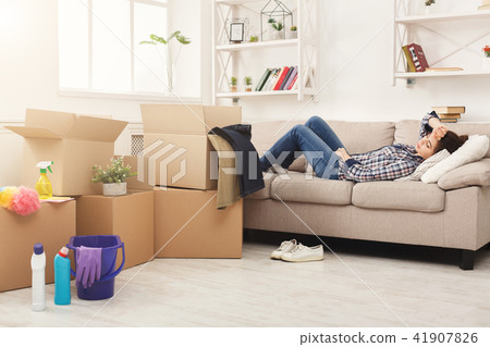 Tired woman having rest after cleaning home Tired woman having rest after cleaning home 41907826