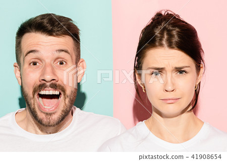 Closeup portrait of young couple, man, woman. One being excited happy smiling, other serious 41908654