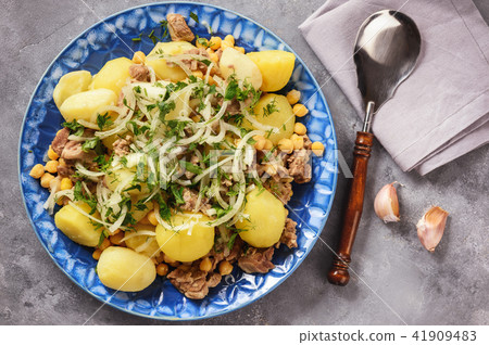 Stewed lamb with potatoes and chikpeas. Stewed lamb with potatoes and chikpeas. 41909483