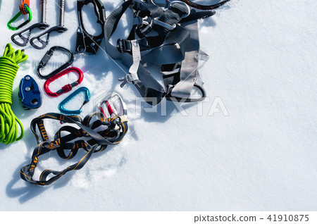 Winter set of equipment of an ice climber with carabiner wounds and a camp thermos. Copy space for Winter set of equipment of an ice climber with carabiner wounds and a camp thermos. Copy space for 41910875