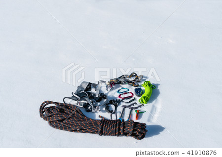 Winter set of equipment of an ice climber with carabiner wounds and a camp thermos. Copy space for 41910876