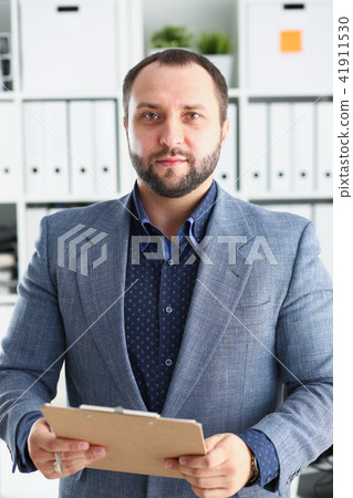 portrait of young handsome promising businessman in office 41911530