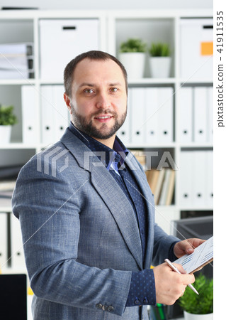 portrait of young handsome promising businessman in office 41911535