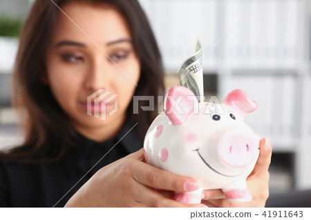woman hold piggybank in arms 41911643