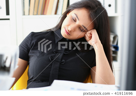 Tired and exhausted woman have a lot of work with documents fall asleep Tired and exhausted woman have a lot of work with documents fall asleep 41911696