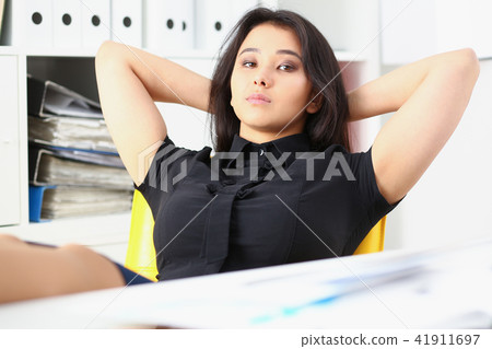 pretty young woman in office sit at table finish all the work have a break can afford to relax 41911697
