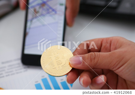 hand hold bitcoin documents smartphone closeup 41912068