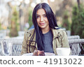 woman smiling outdoors on restaurant cafe terrace 41913022