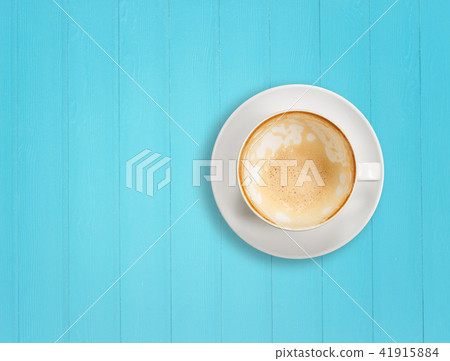 Latte coffee in white cup. On wooden table background. Top view Latte coffee in white cup. On wooden table background. Top view 41915884