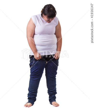 Fat asian woman trying to wear small size jeans isolated on white. Fat and Healthcare concept 41916147