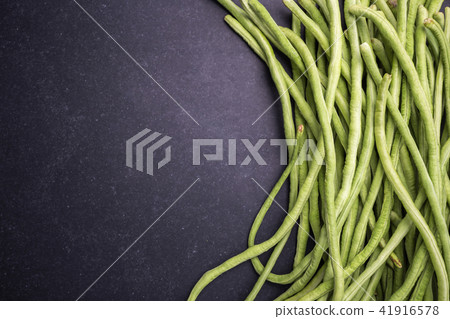 Top view fresh green cowpea or Asparagus bean on black stone 41916578