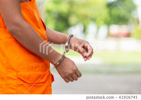 Arms of Thai monk with metal silver handcuff. Arrest the monk or criminal concept 41916745