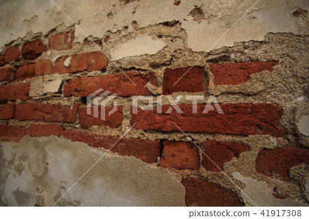 Old cement wall with paint peeling off. 41917308