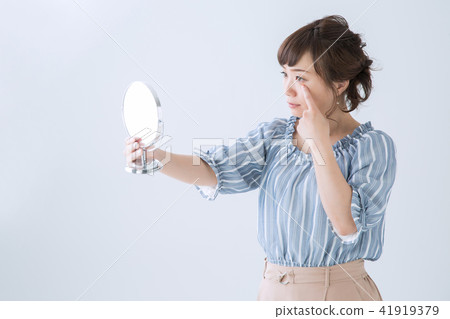 A woman looking in the mirror A woman looking in the mirror 41919379