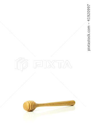 Honey dripping from a wooden honey dipper Honey dripping from a wooden honey dipper 41920997