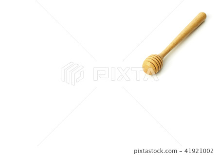 Honey dripping from a wooden honey dipper 41921002