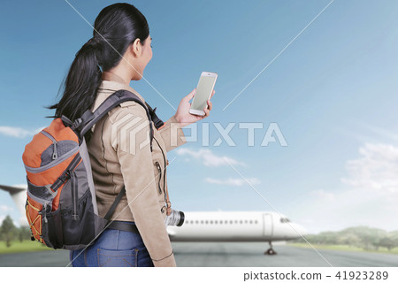 Happy asian tourist woman with phone Happy asian tourist woman with phone 41923289
