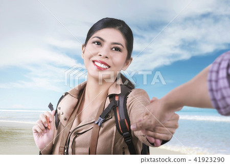 Smiling asian woman following her husband Smiling asian woman following her husband 41923290