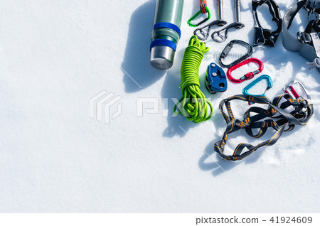 Winter set of equipment of an ice climber with carabiner wounds and a camp thermos. Copy space for 41924609