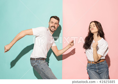 A couple of young man and woman dancing hip-hop at studio. A couple of young man and woman dancing hip-hop at studio. 41925885