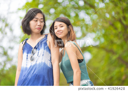 Portrait of Asian girls are relax posing at park. Portrait of Asian girls are relax posing at park. 41926428