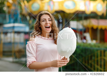 attractive woman holding sweet cotton candy attractive woman holding sweet cotton candy 41926602