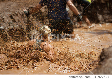 Mud race runners,during extreme obstacle races Mud race runners,during extreme obstacle races 41927527