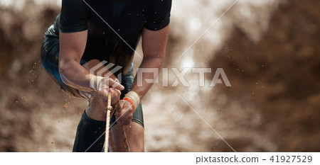 Mud race runners,during extreme obstacle races Mud race runners,during extreme obstacle races 41927529