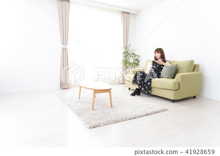 A woman watching TV at home A woman watching TV at home 41928659