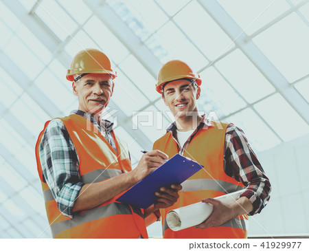 Engineers Makes Notes and Works with Blueprint. 41929977