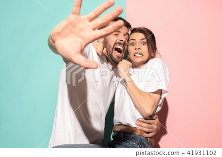 Portrait of the scared man and woman on pink and blue Portrait of the scared man and woman on pink and blue 41931102