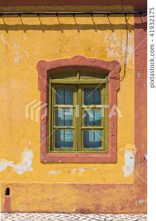 Yellow house with orange details and a window 41932175