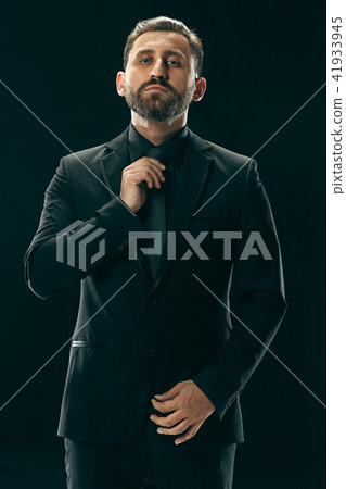 Male beauty concept. Portrait of a fashionable young man with stylish haircut wearing trendy suit 41933945