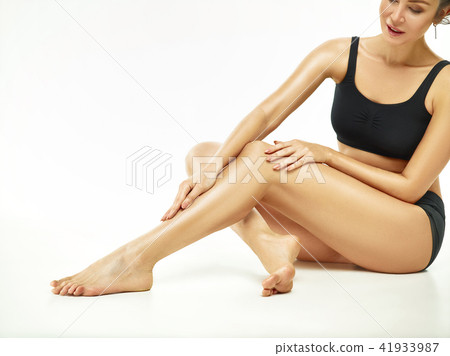 Muscular young woman athlete posing at studio 41933987