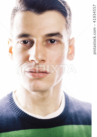 Portrait of a smart serious young man standing against white bac Portrait of a smart serious young man standing against white bac 41934557