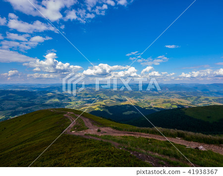 dirt road on the ridge of a tall mountain covered dirt road on the ridge of a tall mountain covered 41938367