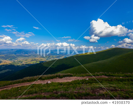 White clouds in the blue sky floating above the mo White clouds in the blue sky floating above the mo 41938370