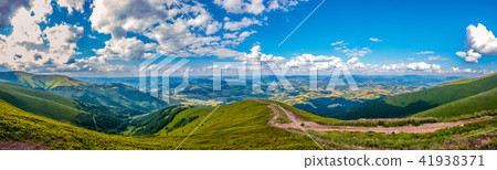 Panoramic view of green hills with mountains, larg Panoramic view of green hills with mountains, larg 41938371