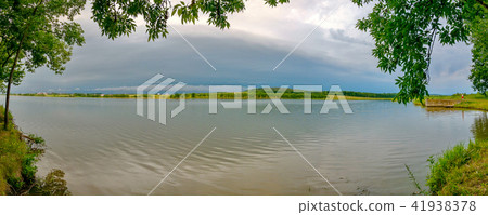 Calm beautiful water surface of the river near the Calm beautiful water surface of the river near the 41938378
