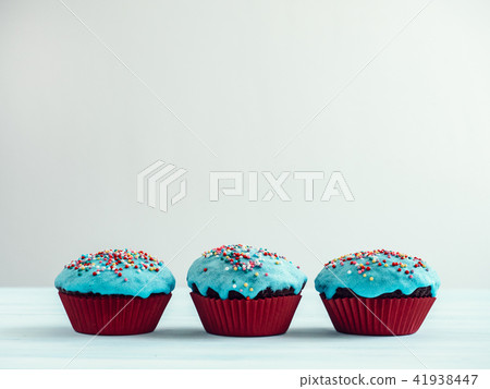 Festive cupcakes with turquoise glaze 41938447