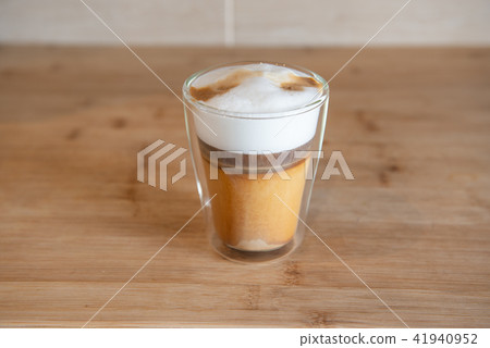 multilayer coffee or cappuccino in a glass cup on wooden table multilayer coffee or cappuccino in a glass cup on wooden table 41940952