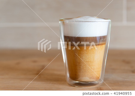 multilayer coffee or cappuccino in a glass cup on wooden table 41940955