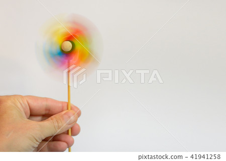 Multi-colored windmill and hand 41941258