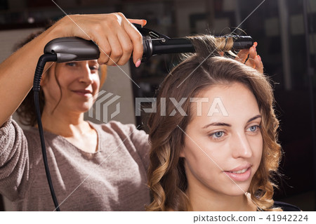 Pretty Woman Is Having A Hair Curling Stock Photo 41942224 Pixta